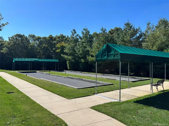 a view of a backyard with swimming pool and porch