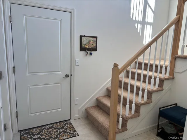 a view of entryway with wooden floor and stairs