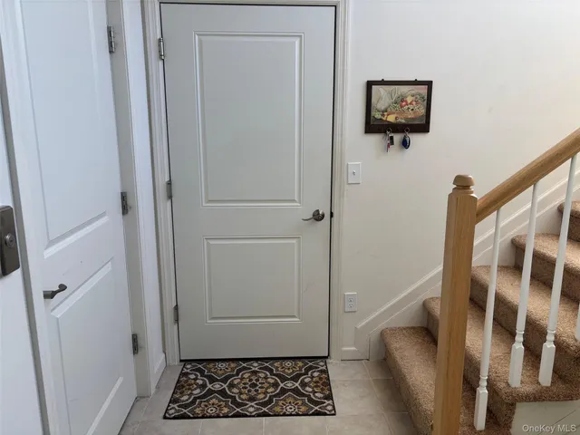 a view of a hallway with wooden floor and a dining room