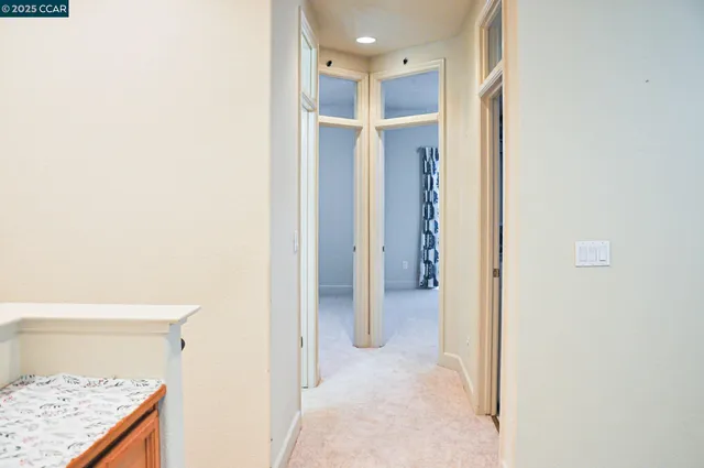 a view of hallway with furniture and a rug