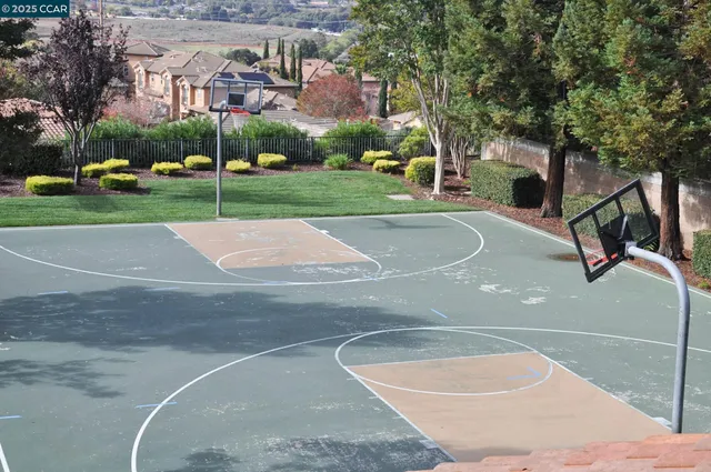 a view of a park with iron fence