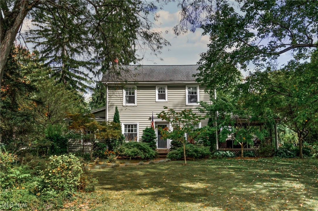 Rear view of house with a yard