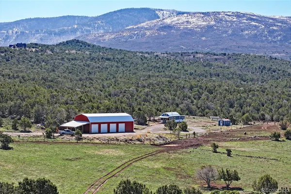 a view of a house with a yard and a mountain