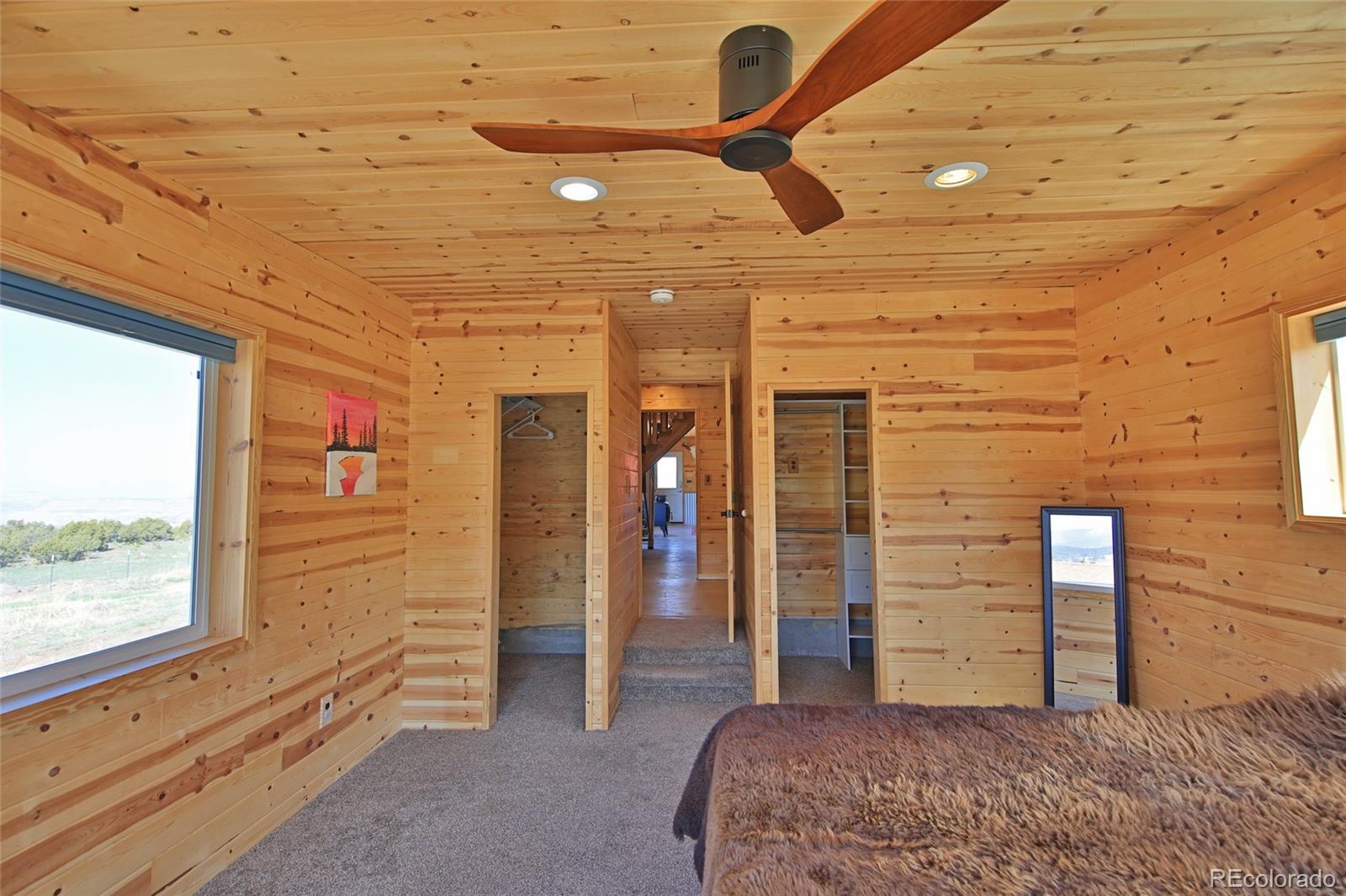 56001 Kk (1 Parcel) Road Molina, CO 81646 - Photo 14 of 43 a bedroom with a bed and a ceiling fan