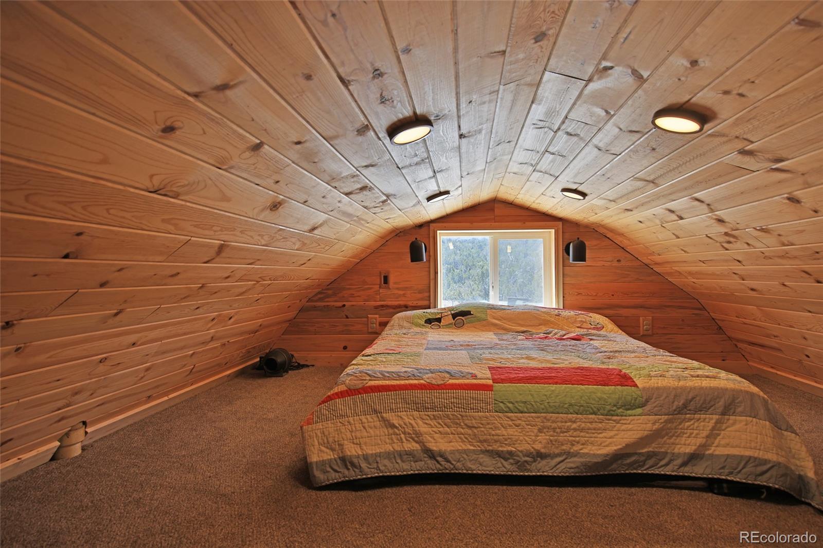56001 Kk (1 Parcel) Road Molina, CO 81646 - Photo 15 of 43 a bedroom with a bed and a chandelier