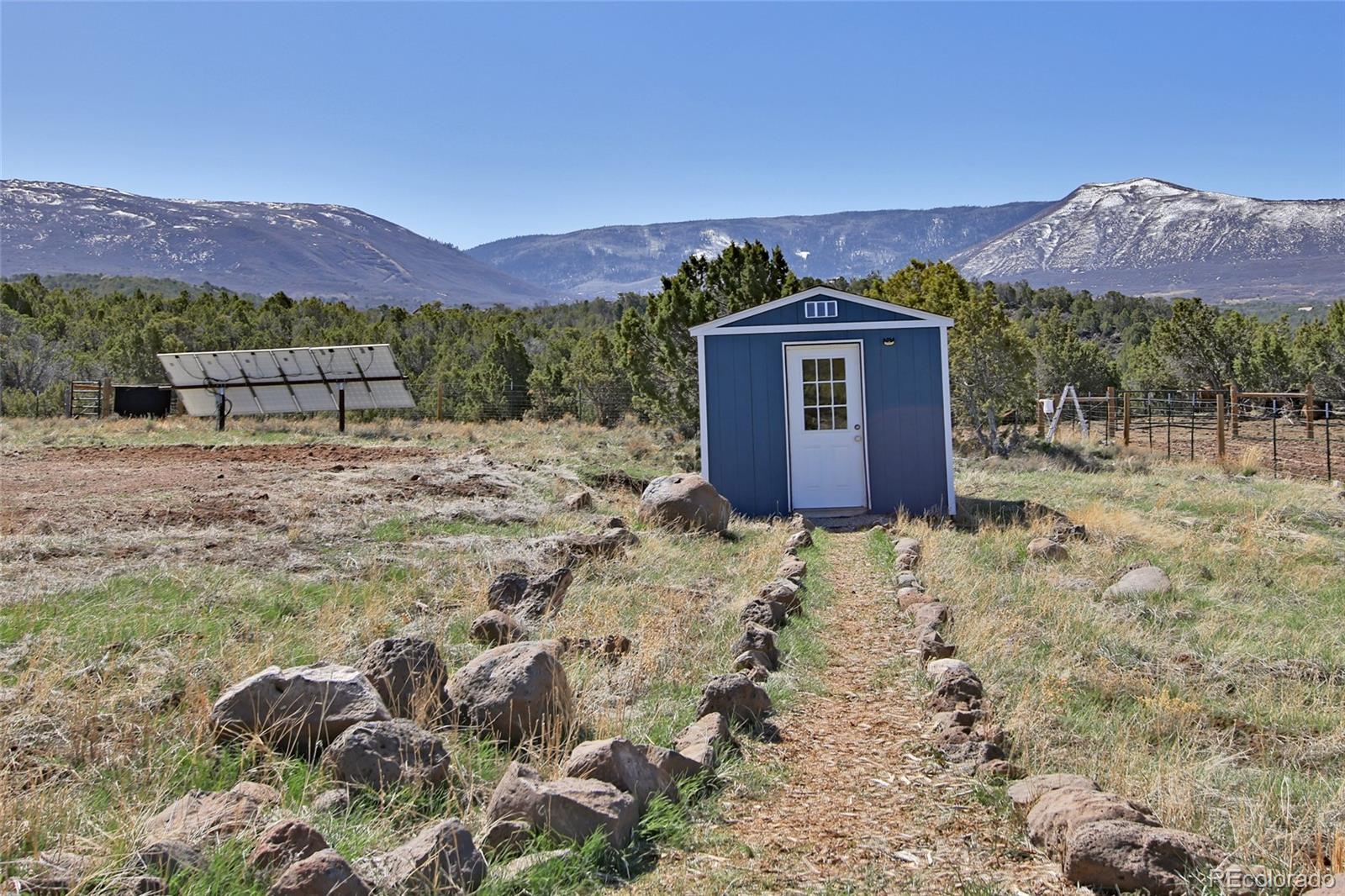 56001 Kk (1 Parcel) Road Molina, CO 81646 - Photo 19 of 43 a view of a house with a mountain and a forest