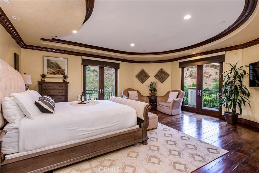 1441 Robmar Drive Beverly Hills, CA 90210 - Photo 15 of 42 a bedroom with a large bed and a large window