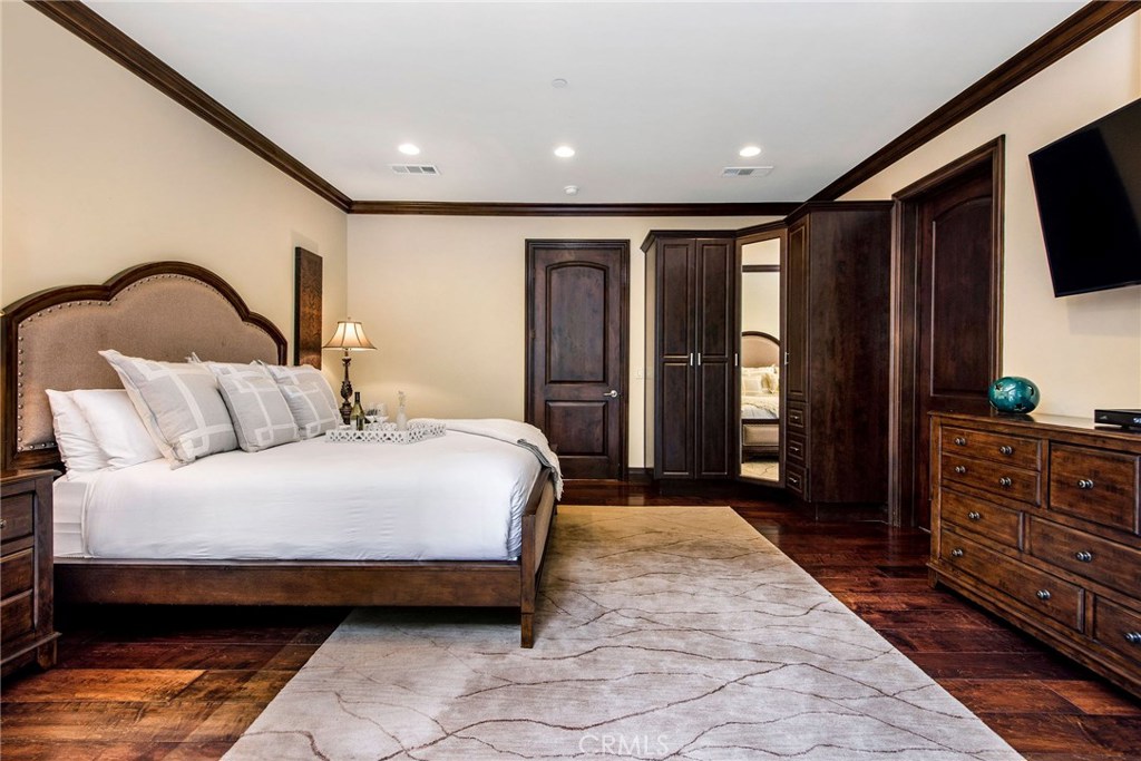 1441 Robmar Drive Beverly Hills, CA 90210 - Photo 30 of 42 a spacious bedroom with a bed and a dresser in it