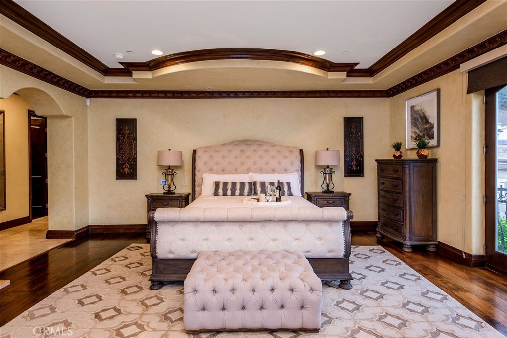1441 Robmar Drive Beverly Hills, CA 90210 - Photo 35 of 42 a large bedroom with a bed and wooden floor