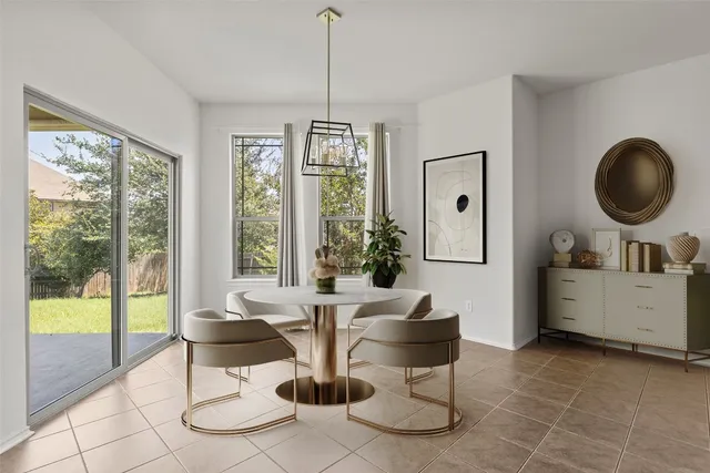 a view of a livingroom with furniture wooden floor and a chandelier