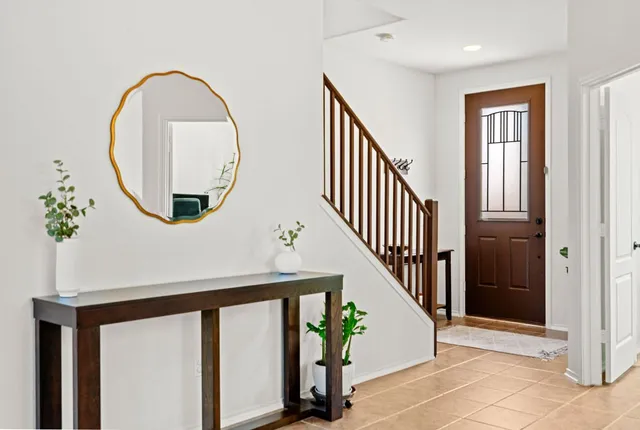an entryway with wooden floor and a front door