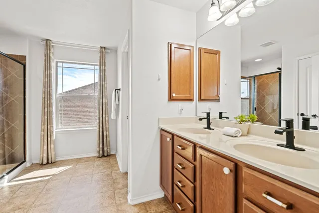 a bathroom with a sink double vanity and a mirror