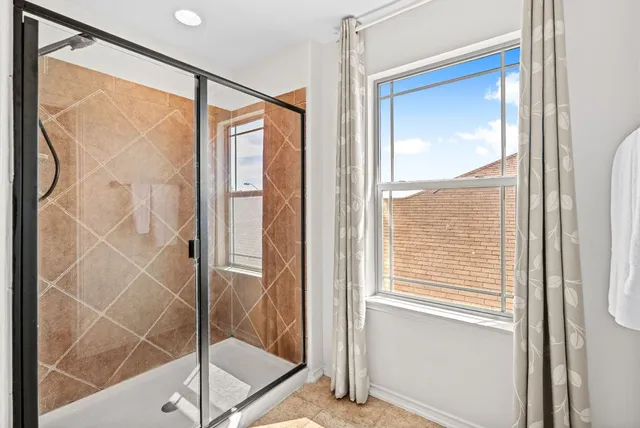 a bathroom with a glass shower door