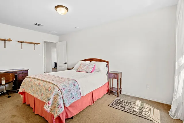 a bedroom with a bed and dresser