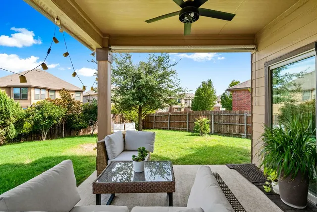a view of a patio with couches chairs and a yard