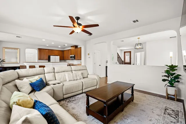a living room with furniture and a potted plant