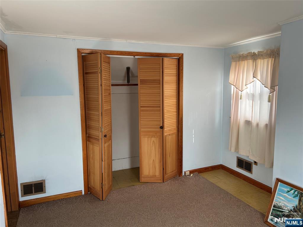 47 Ryle Avenue Little Falls, NJ 07424 - Photo 13 of 18 an empty room with windows and closet