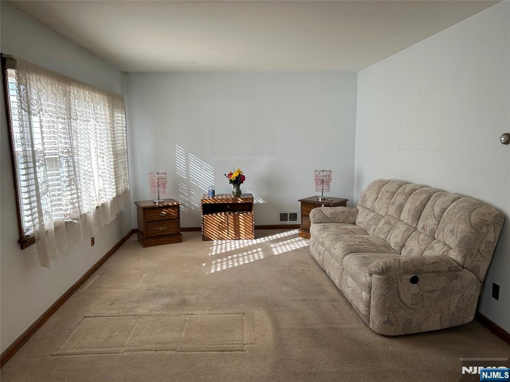 47 Ryle Avenue Little Falls, NJ 07424 - Photo 3 of 18 a living room with furniture and a large window
