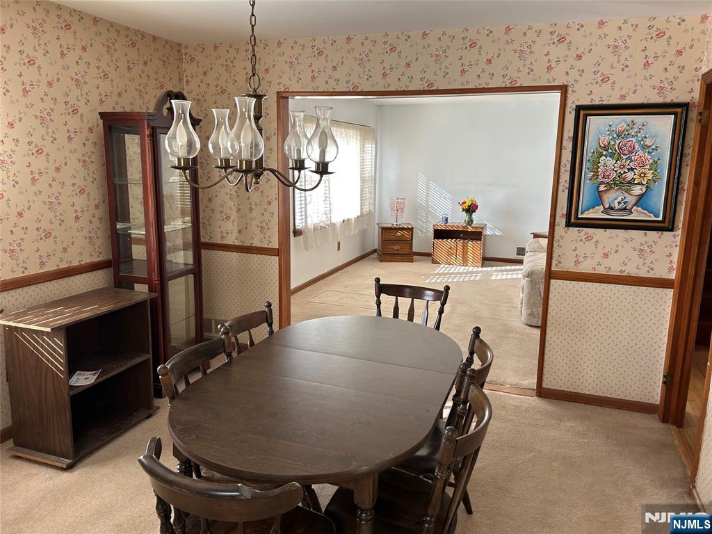 47 Ryle Avenue Little Falls, NJ 07424 - Photo 4 of 18 a dining room with furniture and a chandelier