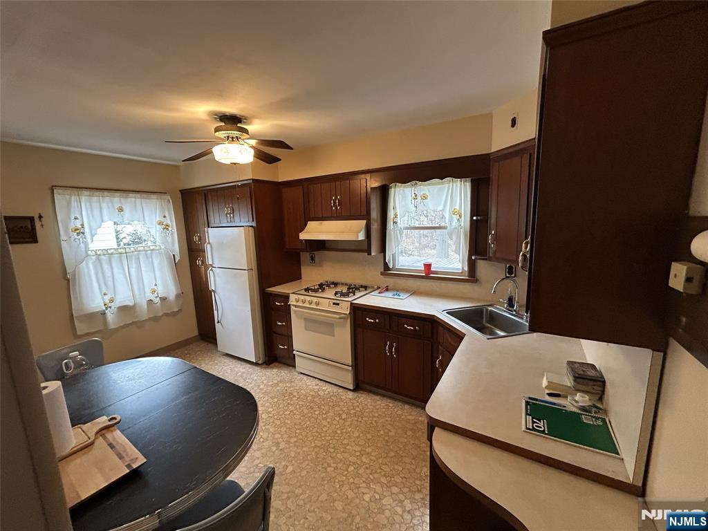 47 Ryle Avenue Little Falls, NJ 07424 - Photo 6 of 18 a kitchen with sink refrigerator and stove