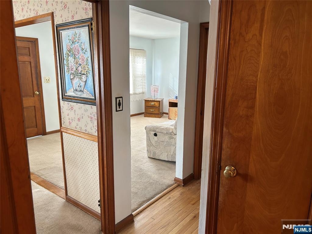 47 Ryle Avenue Little Falls, NJ 07424 - Photo 8 of 18 a view of a hallway with wooden floor and staircase
