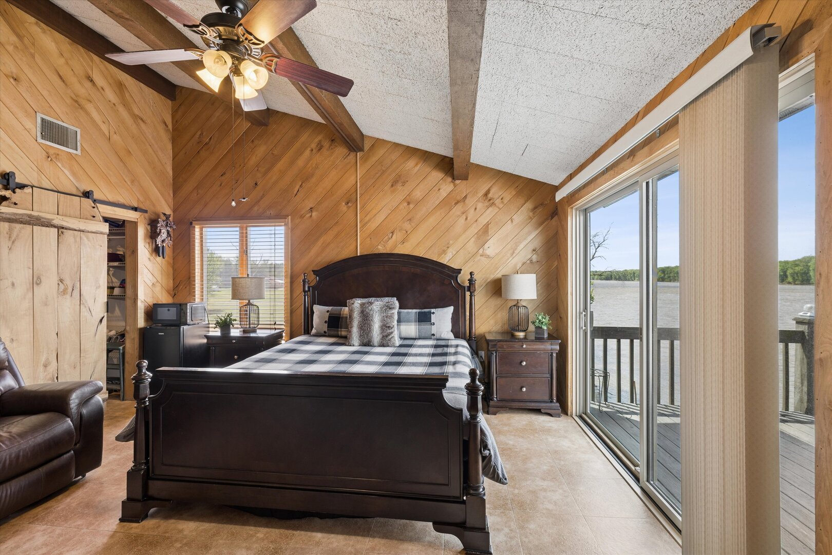 14839 Vans Road Fulton, IL 61252 - Photo 29 of 70 a bedroom with a bed next to a window with a chandelier