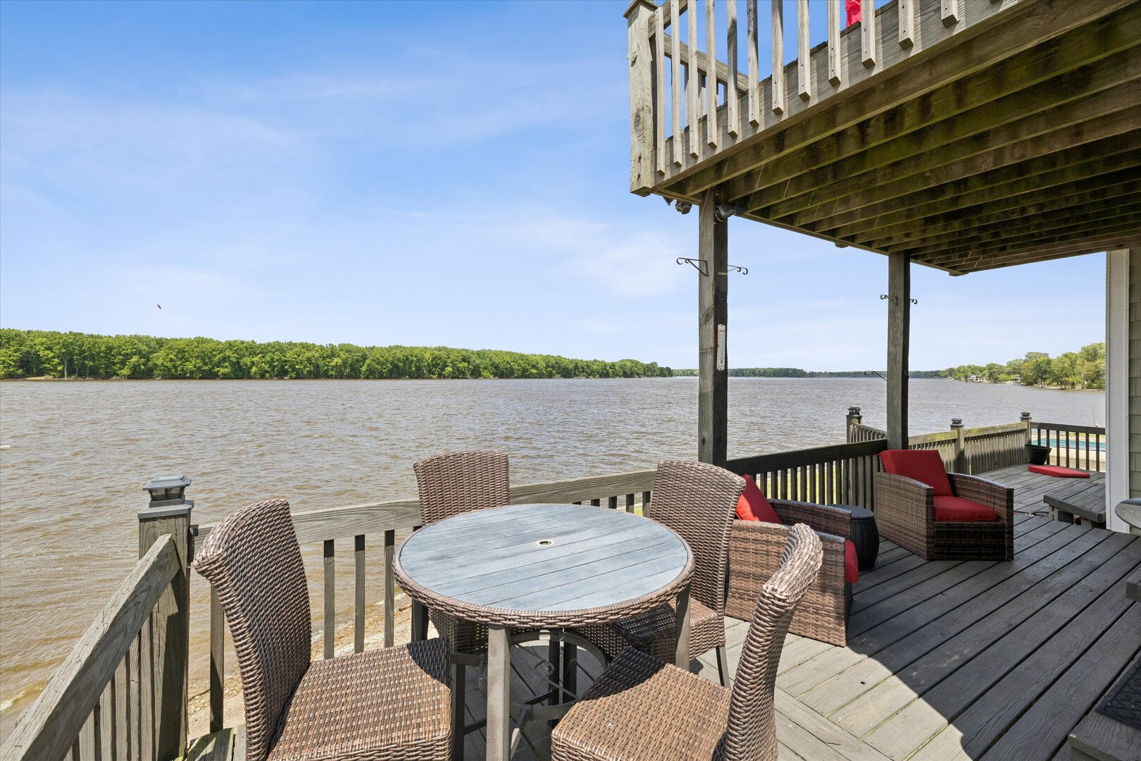 14839 Vans Road Fulton, IL 61252 - Photo 37 of 70 a view of a roof deck with couches wooden floor and fence