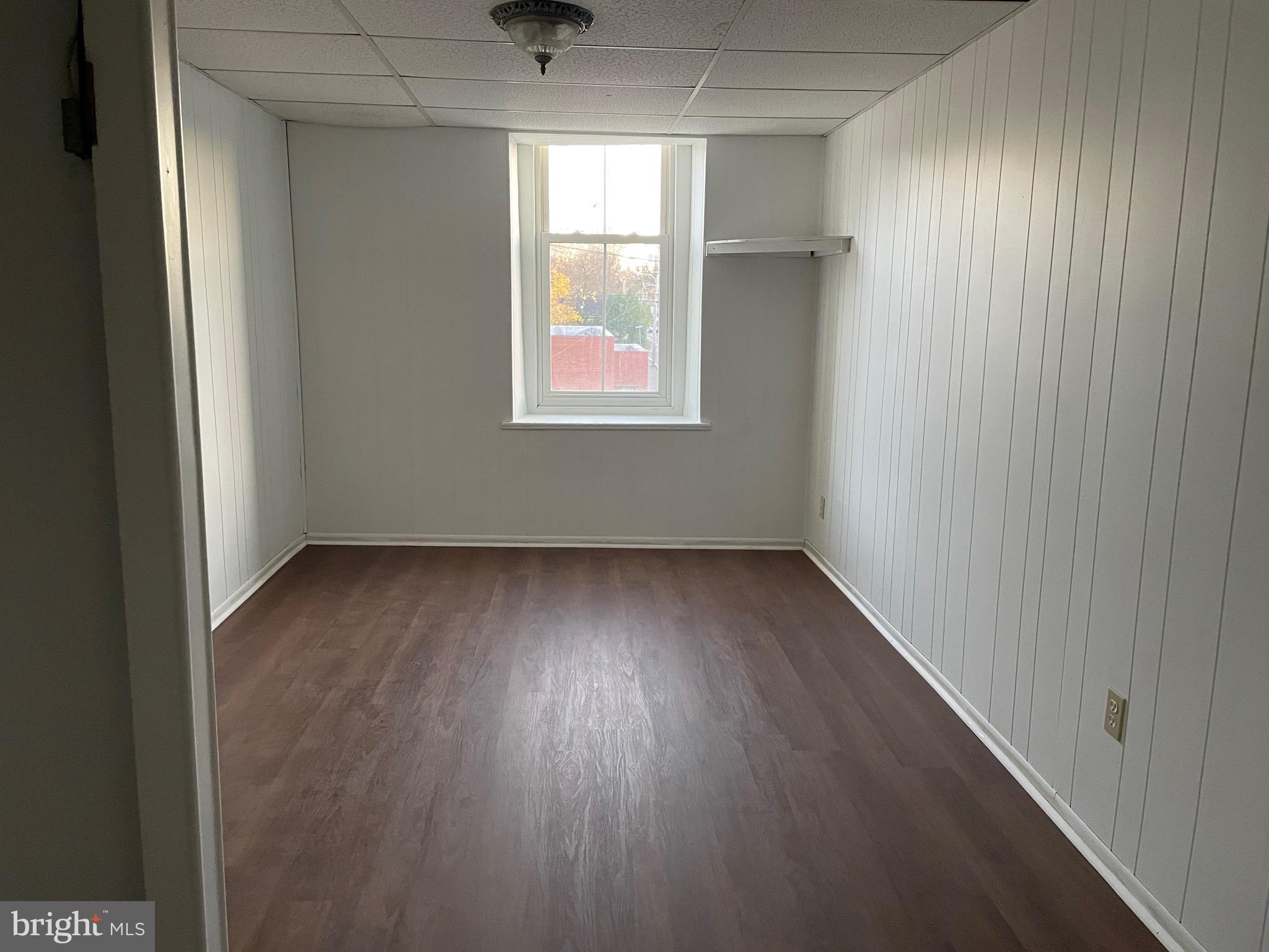 91 A Delaware Road, Unit 2A Riegelsville, PA 18077 - Photo 3 of 10 an empty room with wooden floor and windows