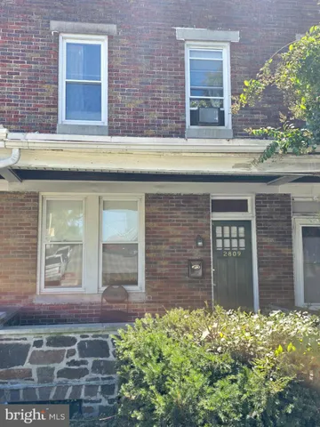 front view of a brick house with a large windows
