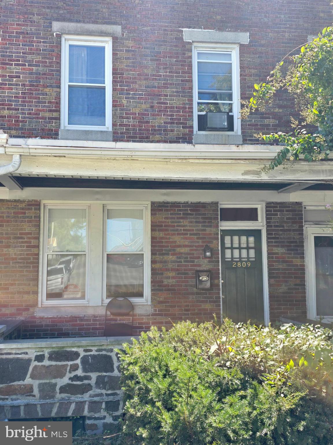 front view of a brick house with a large windows