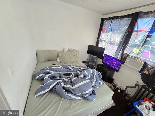 a bedroom with a bed and dresser