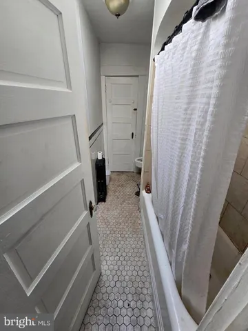 a bed room with a bed and a chair