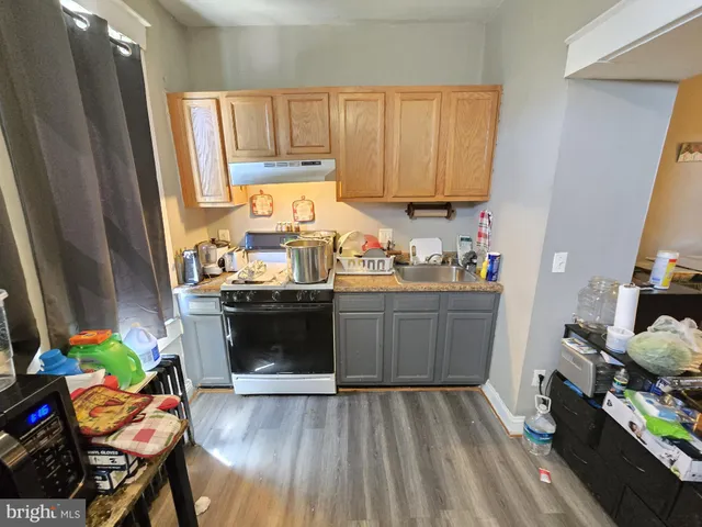 a kitchen with a refrigerator and a stove top oven