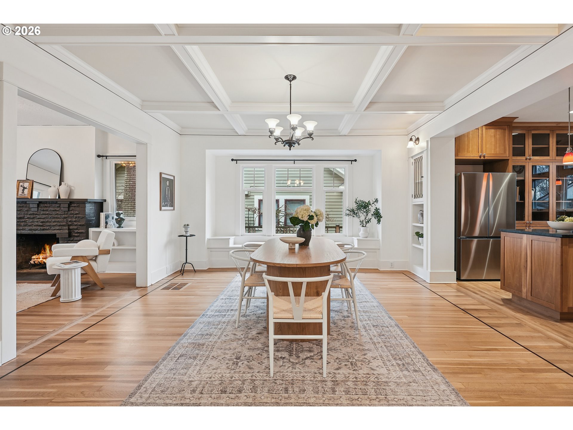2715 Northeast 38th Avenue Portland, OR 97212 - Photo 19 of 45 a dining room with wooden floor a chandelier a wooden table and chairs