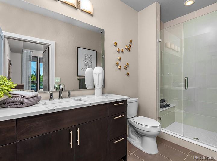 6618 East Lowry Boulevard, Unit 307 Denver, CO 80230 - Photo 13 of 23 a bathroom with a granite countertop sink toilet and shower