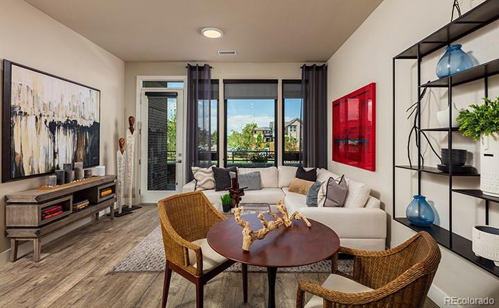 6618 East Lowry Boulevard, Unit 307 Denver, CO 80230 - Photo 2 of 23 a living room with furniture a flat screen tv and a floor to ceiling window