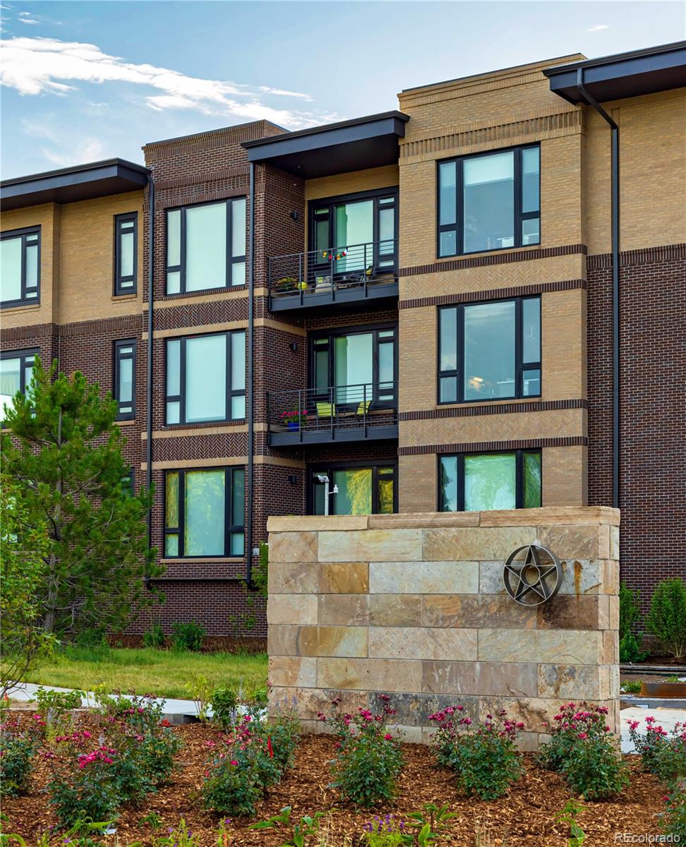 6618 East Lowry Boulevard, Unit 307 Denver, CO 80230 - Photo 21 of 23 a front view of a house with a garden