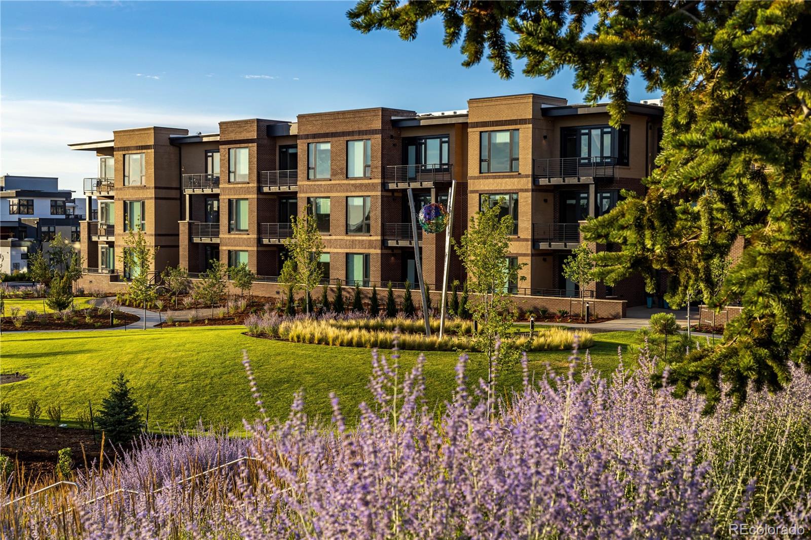 6618 East Lowry Boulevard, Unit 307 Denver, CO 80230 - Photo 23 of 23 a front view of a residential apartment building with a yard