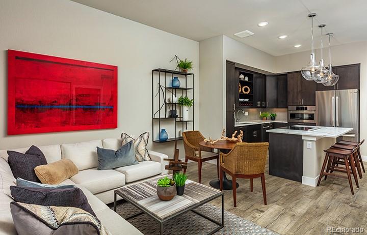 6618 East Lowry Boulevard, Unit 307 Denver, CO 80230 - Photo 8 of 23 a living room with furniture kitchen view and a chandelier