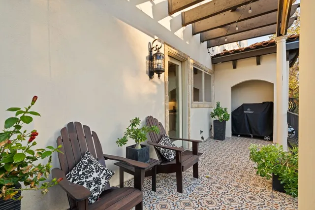 a outdoor living room with furniture and a potted plant
