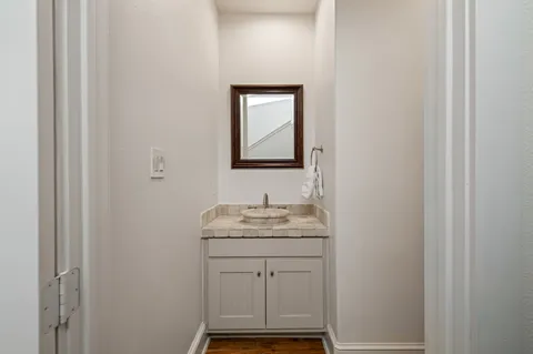 a bathroom with a sink toilet and mirror
