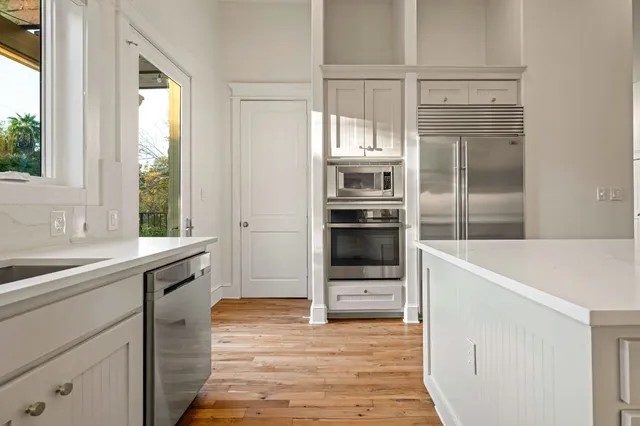 a kitchen with granite countertop a refrigerator and a sink