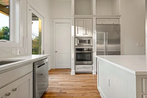 a kitchen with granite countertop a refrigerator and a sink