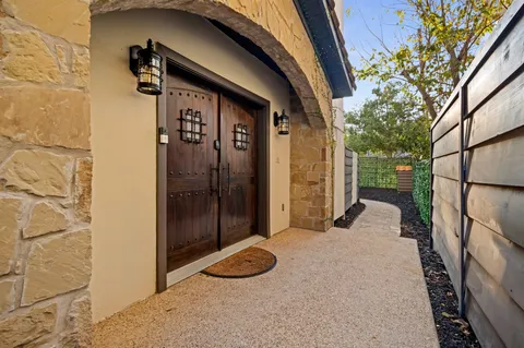 a view of a door and chair in the patio