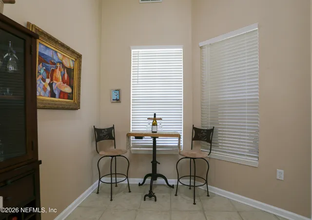 a dining room with furniture and window