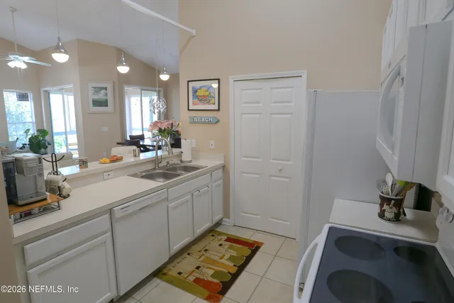 a kitchen with a sink cabinets and wooden floor