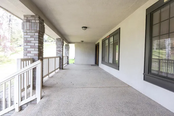 a view of a livingroom with furniture a ceiling fan and hardwood floor