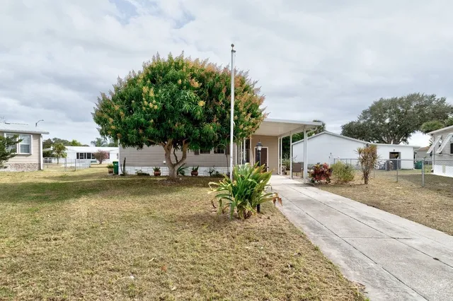 a front view of a house with a yard and a garage