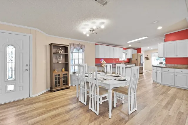a view of a dining room with furniture and wooden floor