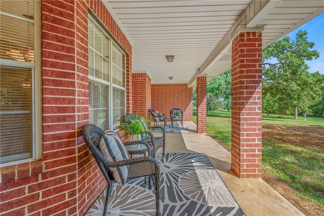 1110 County Road 439 Dime Box, TX 77853 - Photo 38 of 50 a view of a patio with a table and chairs and floor to ceiling window